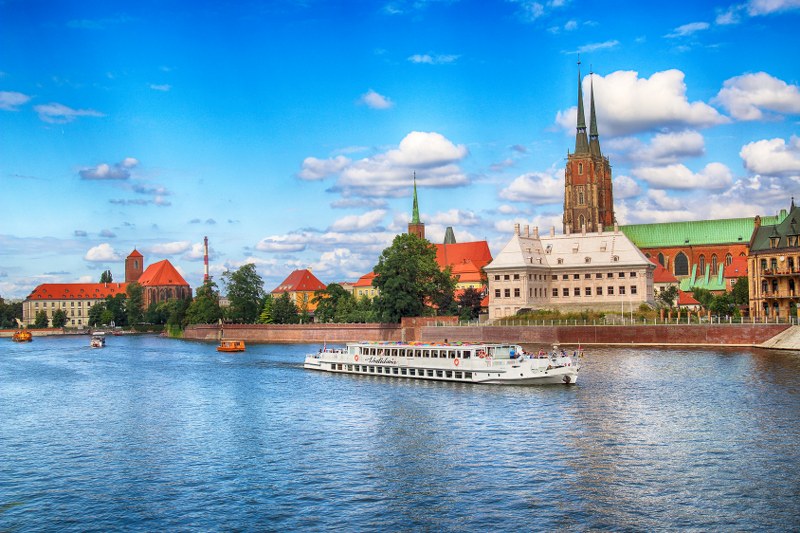 WROCLAW, POLAND - AUGUST 14, 2017: Wroclaw Old Town. Cathedral Island (Ostrow Tumski) is the oldest part of the city. Odra River, boats and historic buildings on a summer day.